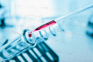 Closeup of a pipetting medium in a test tube during cell line development