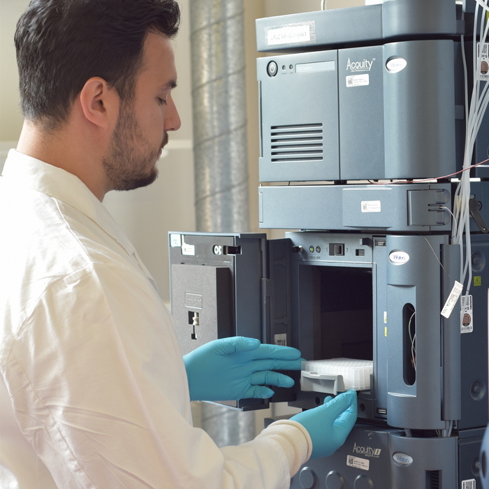 Scientist prepares samples for UPLC-MS analysis.